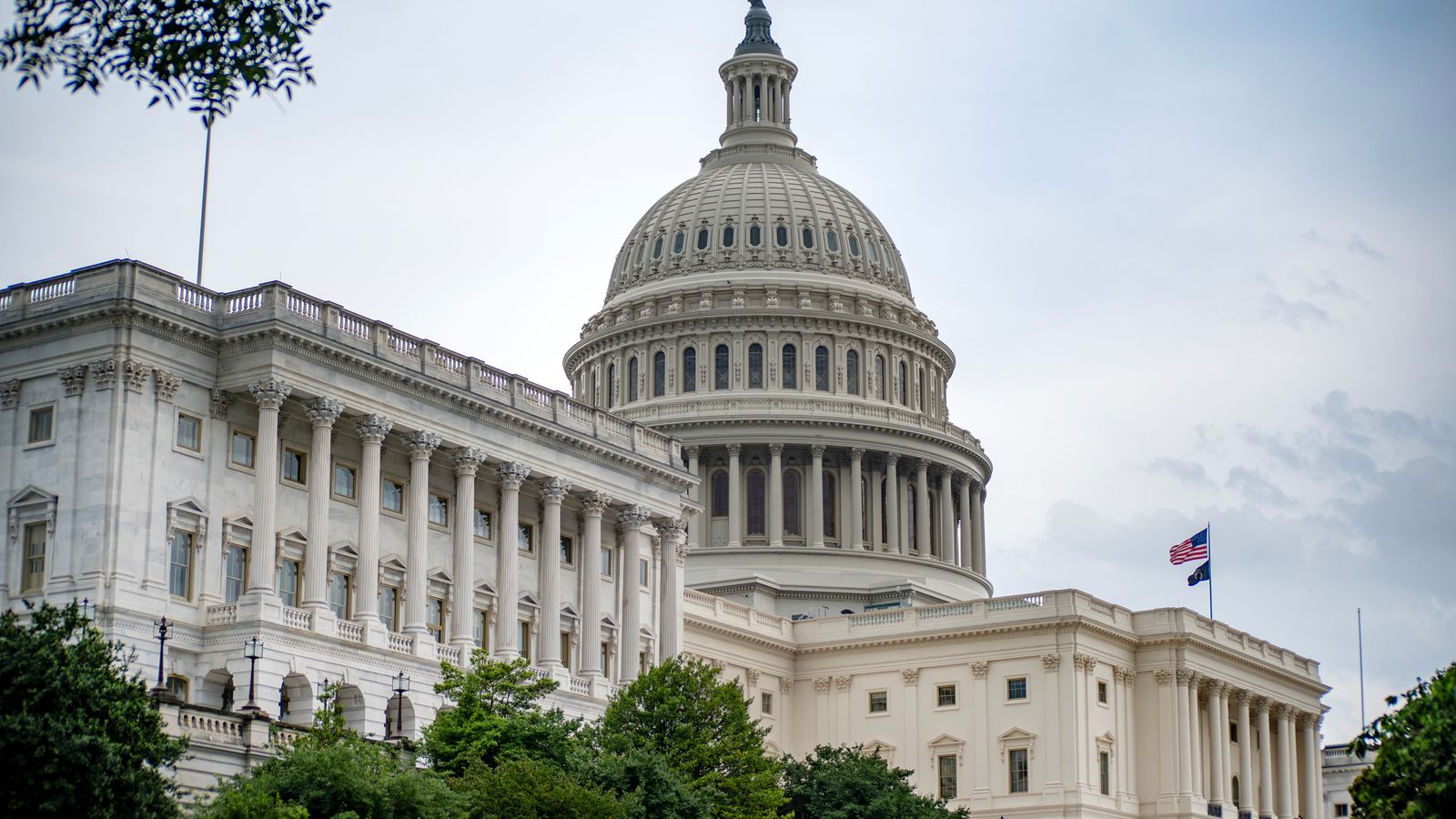 United States Capitol dome with an American flag flying beside it