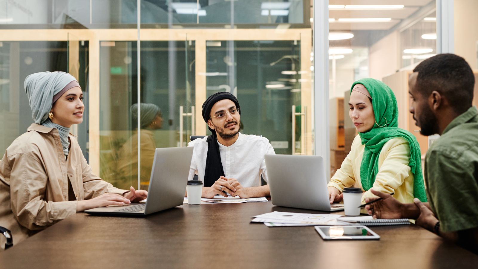 Campaign strategy team reviewing a media plan around a conference table